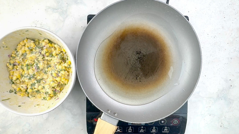 vegetable oil heating in frying pan