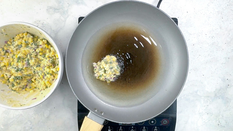 corn and jalapeño fritter in oil