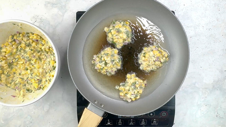 cooking four corn and jalapeño fritters