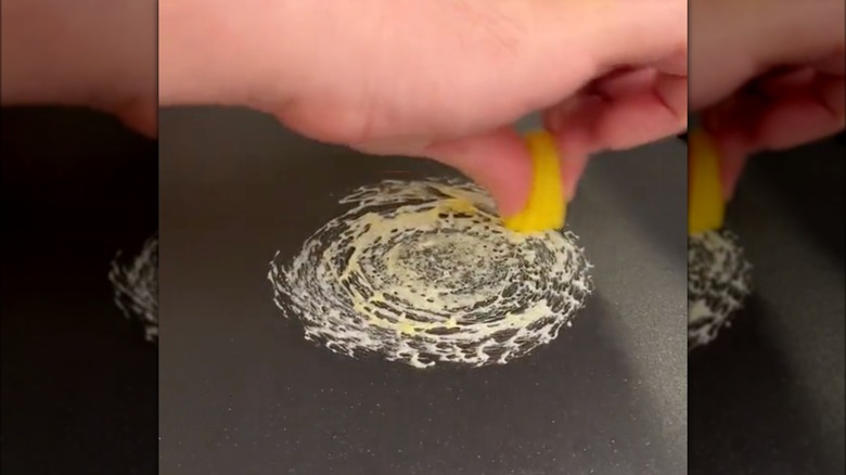 Person making candy spiderweb