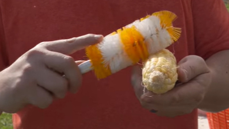 Man brushing corn