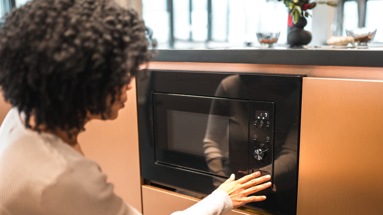 Woman using microwave