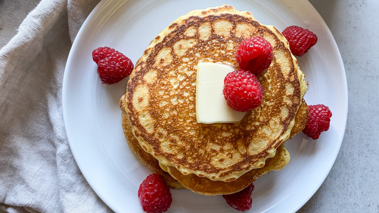 cornbread pancakes with butter and raspberries