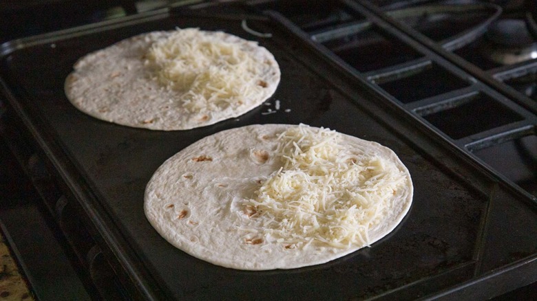 tortillas topped with shredded cheese