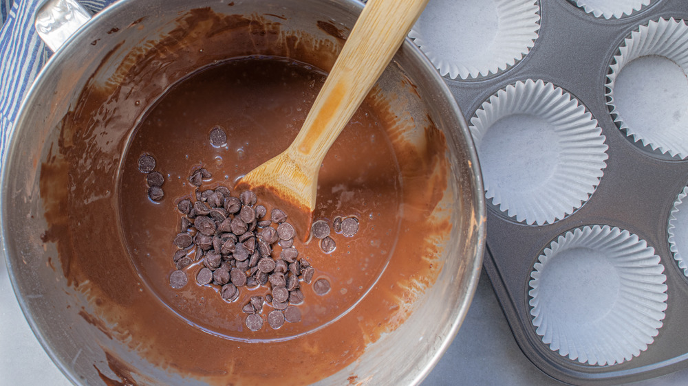 stirring in chocolate chips for Costco copycat chocolate muffins