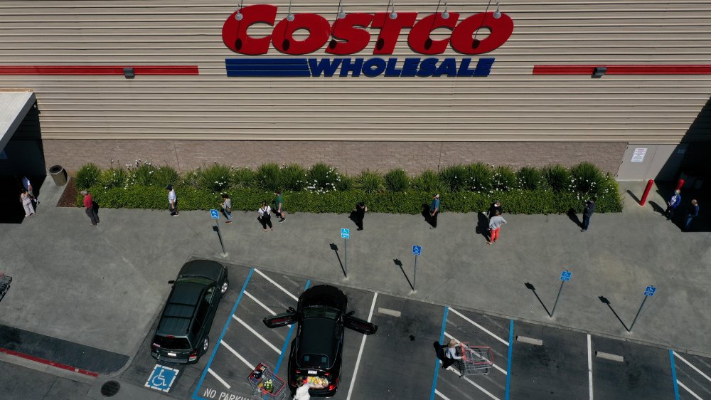 Costco store customers line up outside social distancing