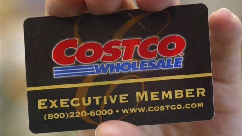 Customer holding membership card