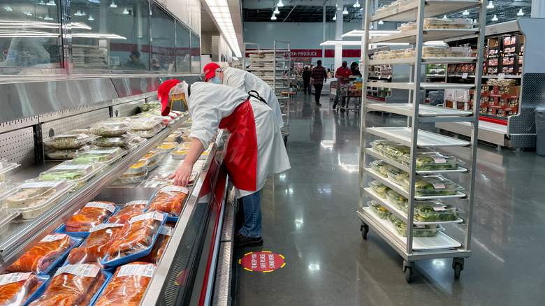 Workers restocking the Costco deli