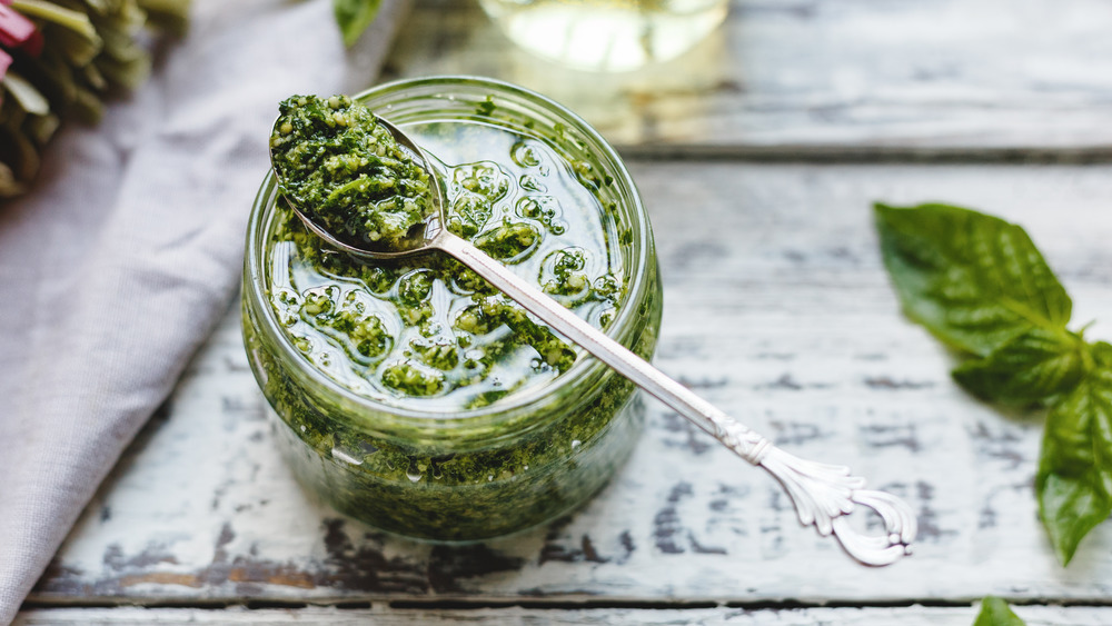 Pesto in a jar with a spoon