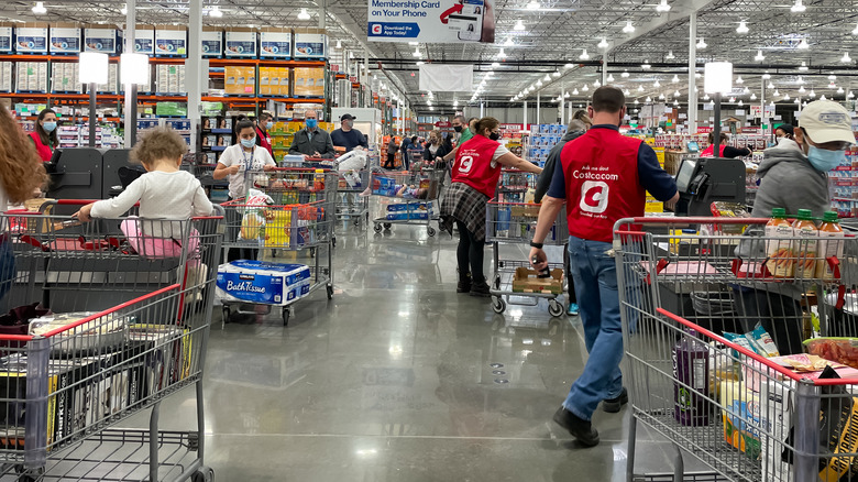 Inside a Costco store as people check out at registers