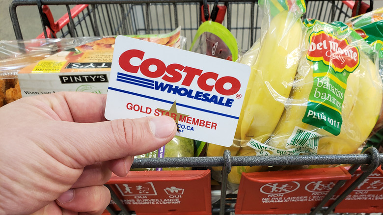 Customer holding a Costco membership card