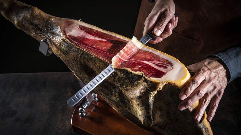 Thinly slicing jamon Iberico 