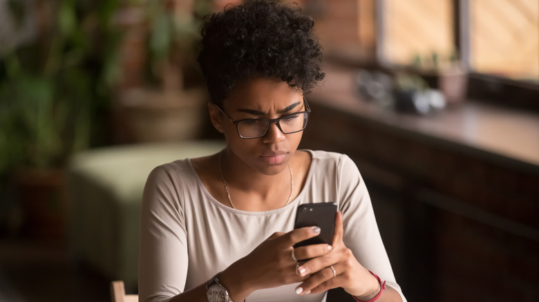 Concerned woman on her phone