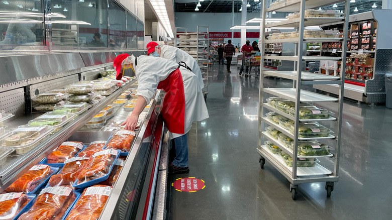 Costco employees restocking shelves