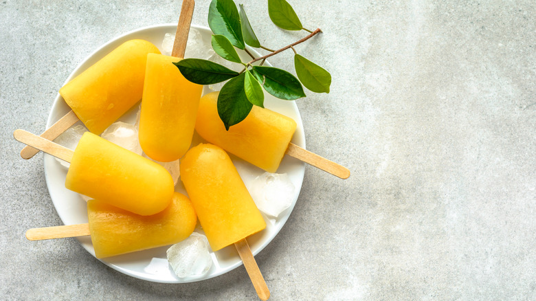 Fruit ice pops on white plate