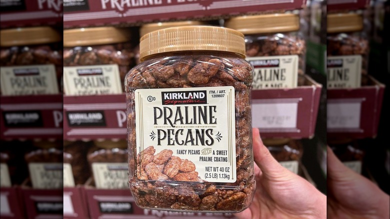 holding Kirkland praline pecan container