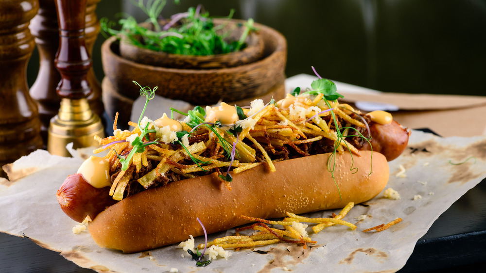 Grilled hot dog with fixings on table