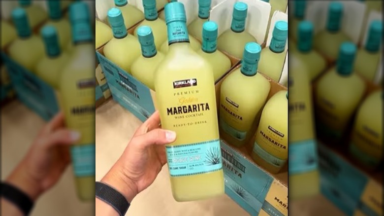 Person holding a bottle of Costco's ready-to-drink Kirkland Signature Premium Golden Margaritas