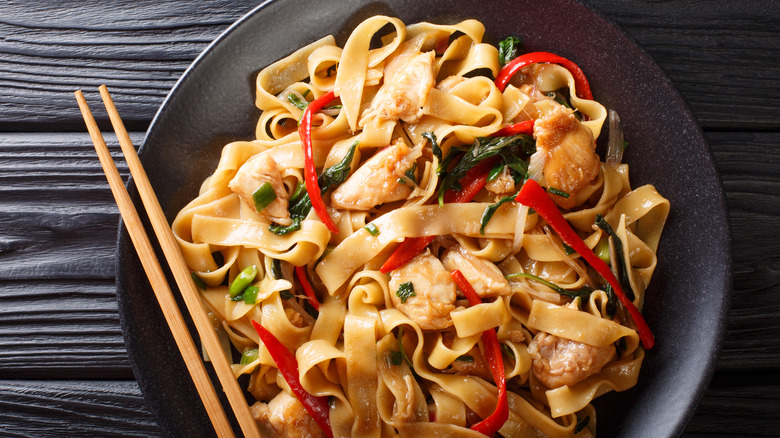 plate of drunken noodles with chopsticks