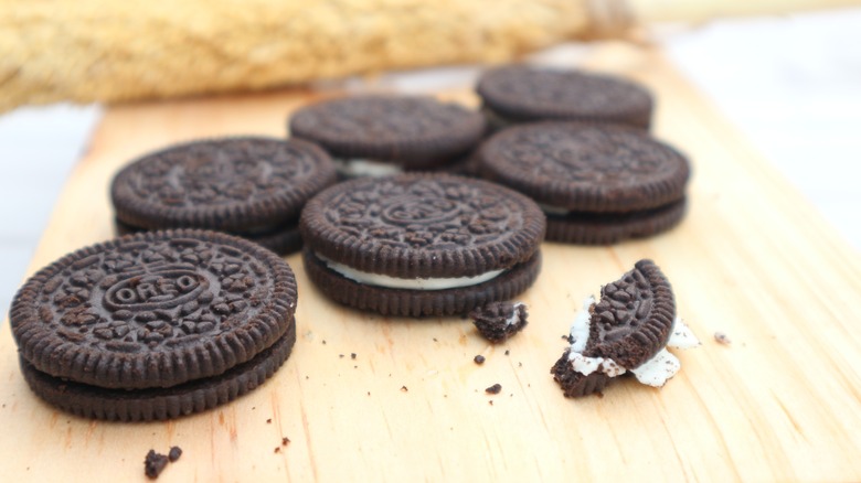 broken oreos on a cutting board