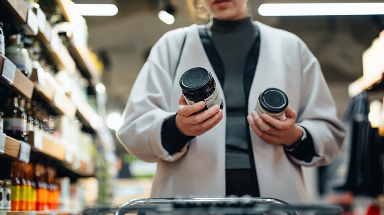 woman comparing food jars