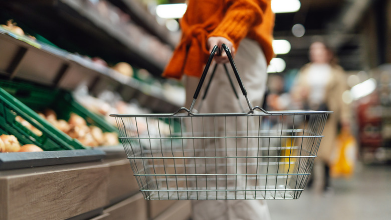 woman holding grocery basket