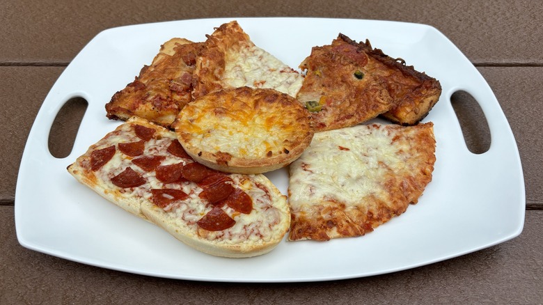 tray of various frozen pizza slices