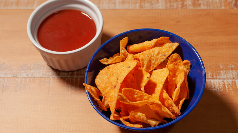 Bowl of nacho cheese chips with sauce