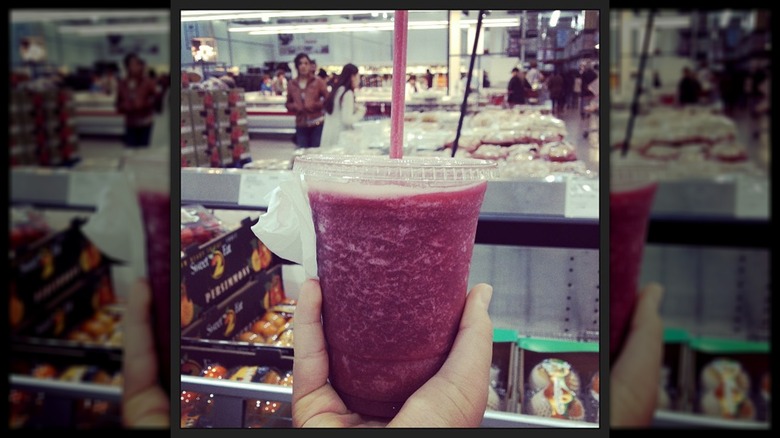 Person holding Costco berry smoothie