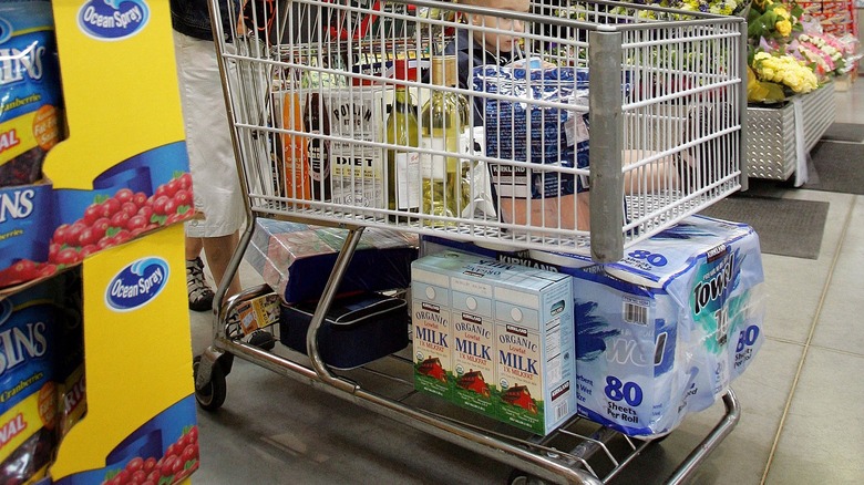 shopping cart with organic milk, paper towels, and groceries