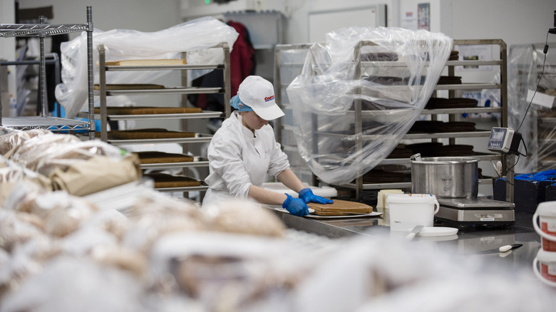 Costco baker works on a cake