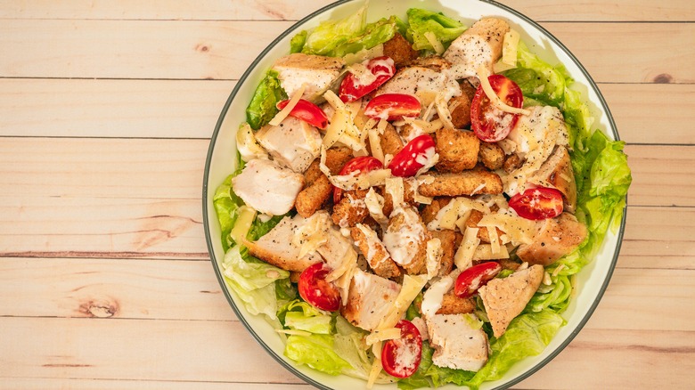 chicken caesar salad with croutons and tomatoes