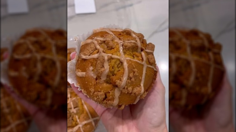 Hand holding pumpkin streusel muffin from Costco