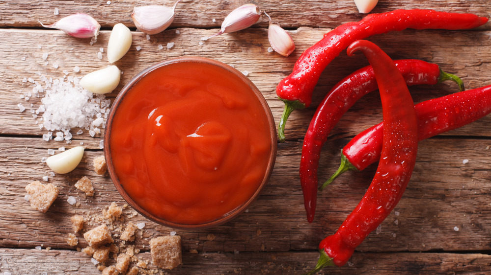 Sriracha sauce in a bowl on cutting board