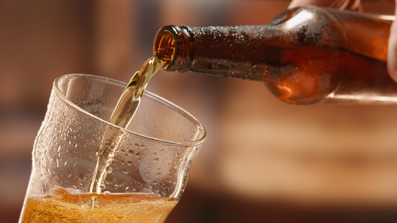 beer being poured into a glass 