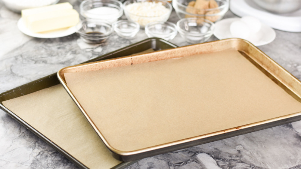 baking sheets lined with parchment paper on the counter