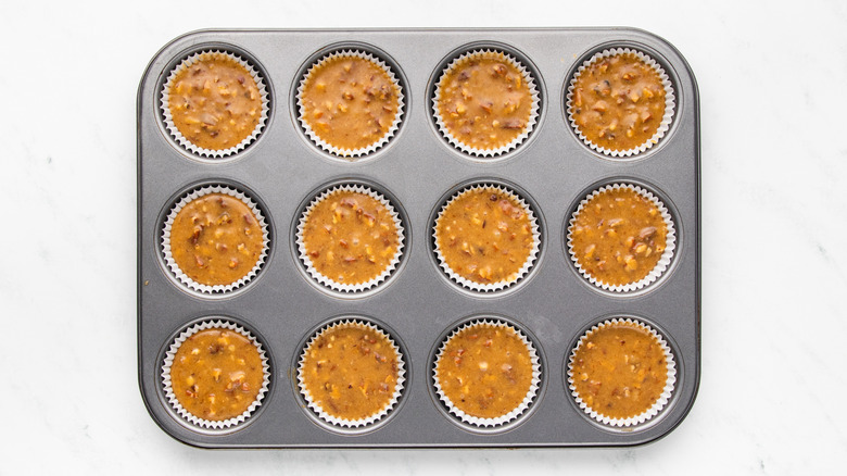 Pecan pie muffin batter in muffin pan