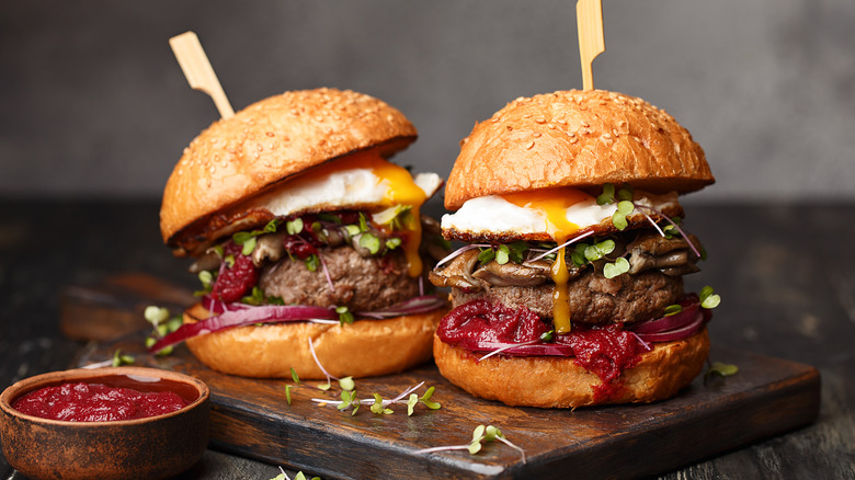 burgers with fried eggs and other toppings