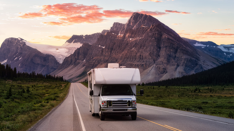 Camper van on road near mountains