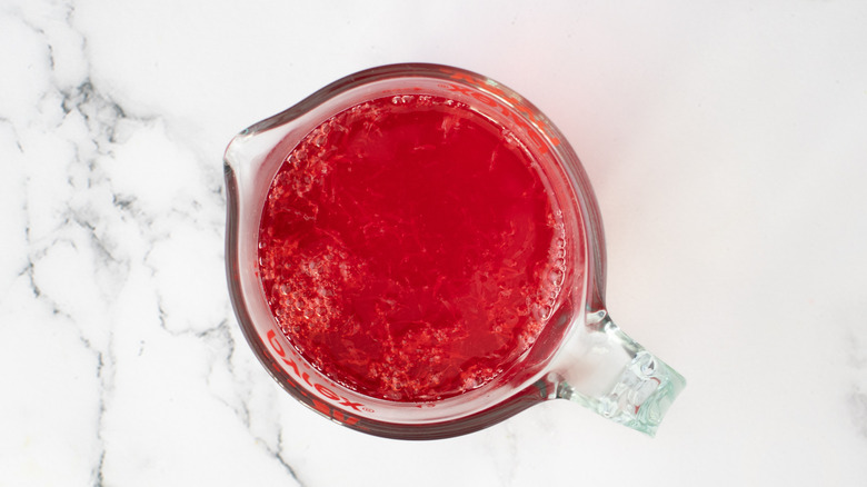 red jello mix in measuring cup