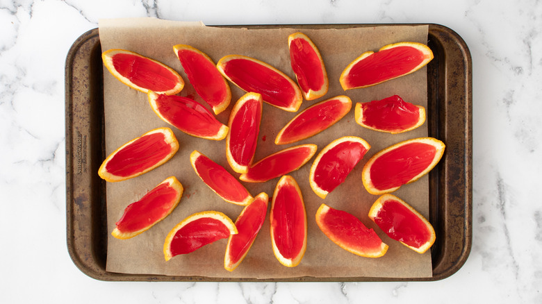 sliced orange jello shots on baking sheet