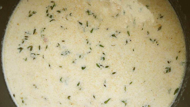 creamy soup with thyme leaves