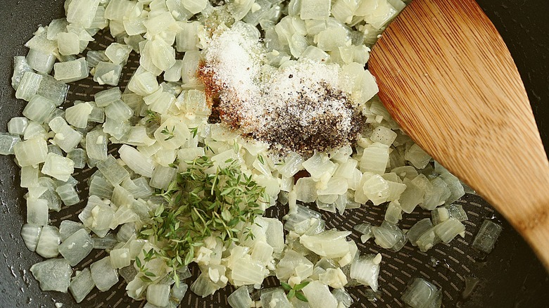 diced onion and seasonings with spoon