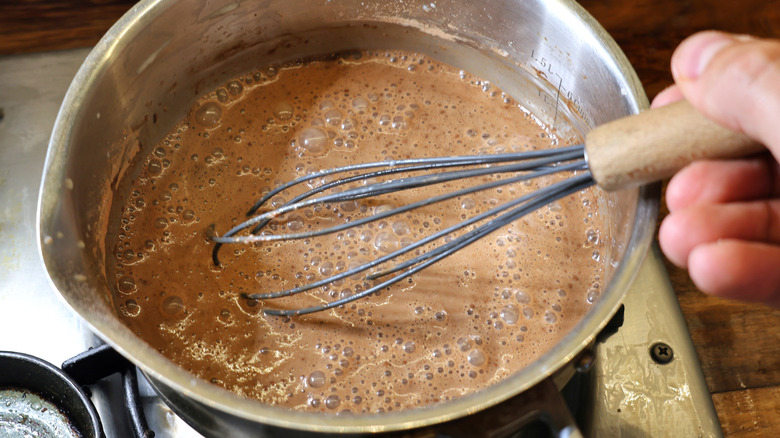 whisk in saucepan of hot chocolate