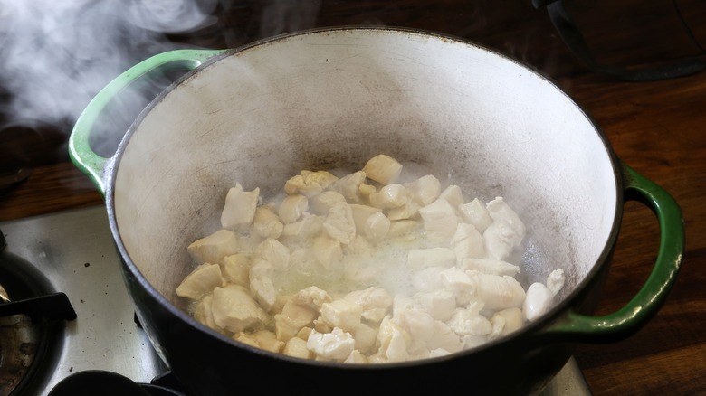 steaming pot of diced chicken