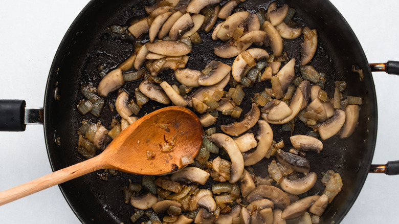 mushroom and onion in pan 