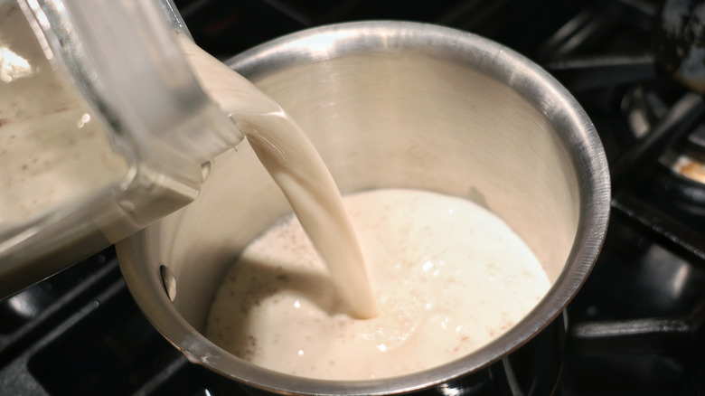 pouring horchata into saucepan