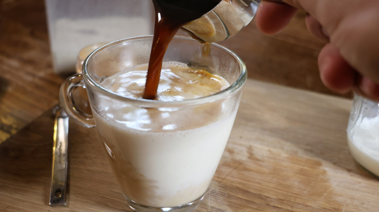 pouring espresso into mug of horchata