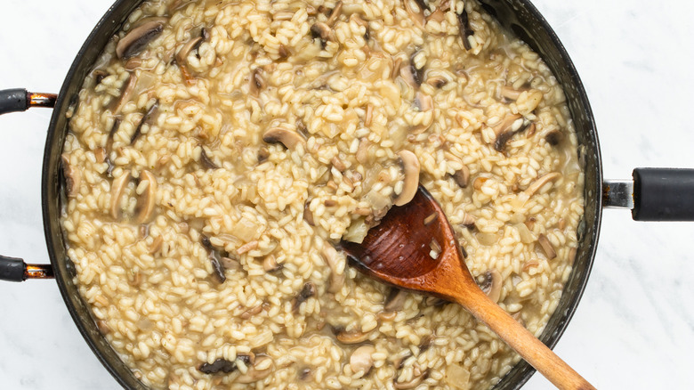 creamy mushroom risotto in pan 