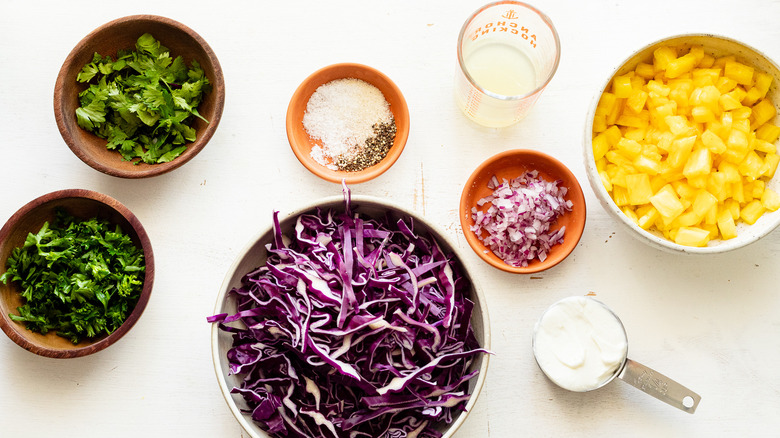 ingredients for creamy pineapple coleslaw topped with parsley